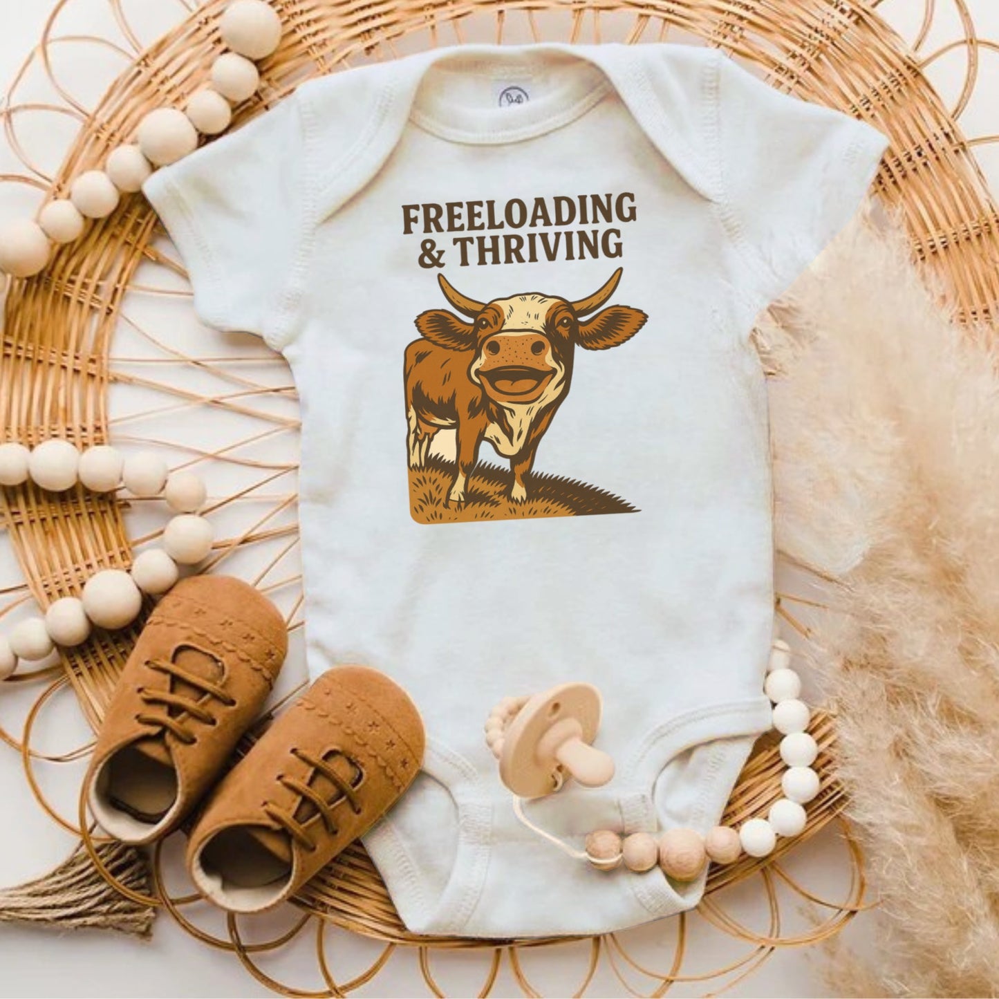 Freeloading and Thriving Cow Graphic Baby Onesie product type